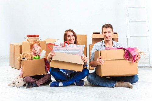 Movers handling furniture and boxes in a Lambeth street