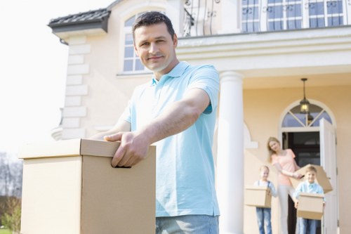 Trained removals staff handling furniture carefully during a home move
