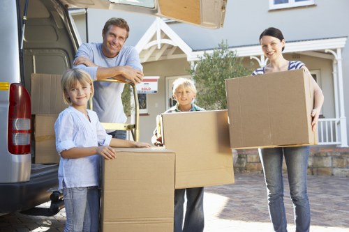Mover carrying items through a residential property in Lambeth