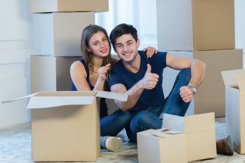 Team member using PPE while moving boxes in a property